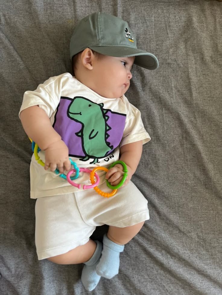 "Smiling toddler sitting on play mat"