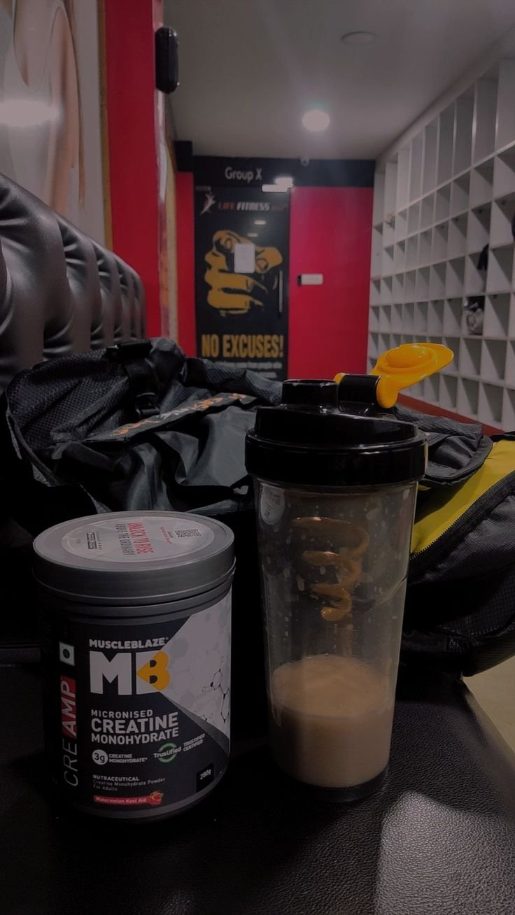 “Healthy-looking protein shake beside powder scoop on a bench, representing post-workout support with a reminder to use supplements safely.”